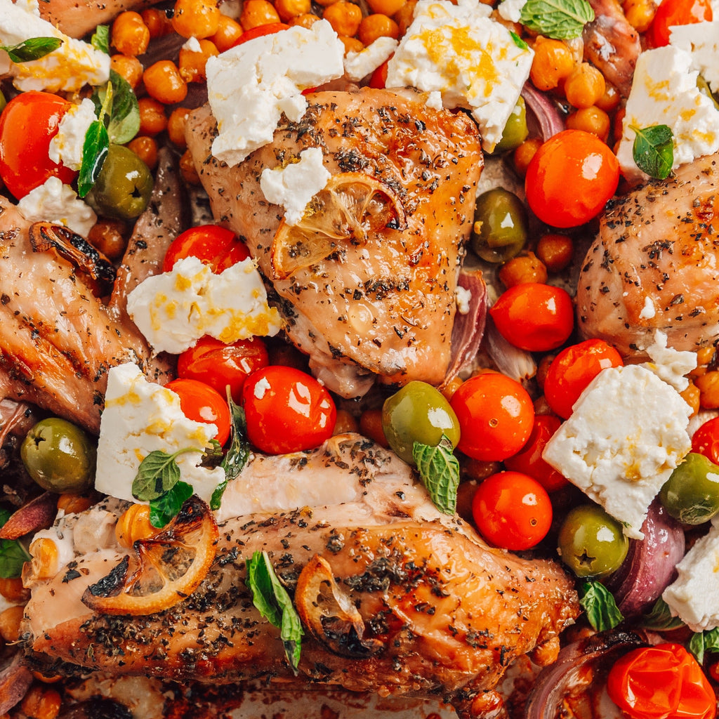 image of chicken wings and breast cooked on a sheet pan with tomatoes, olives, and feta cheese