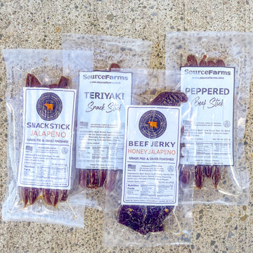 Image contains 4 packages of Source Farms Beef Jerky and Snack Sticks laid on concrete