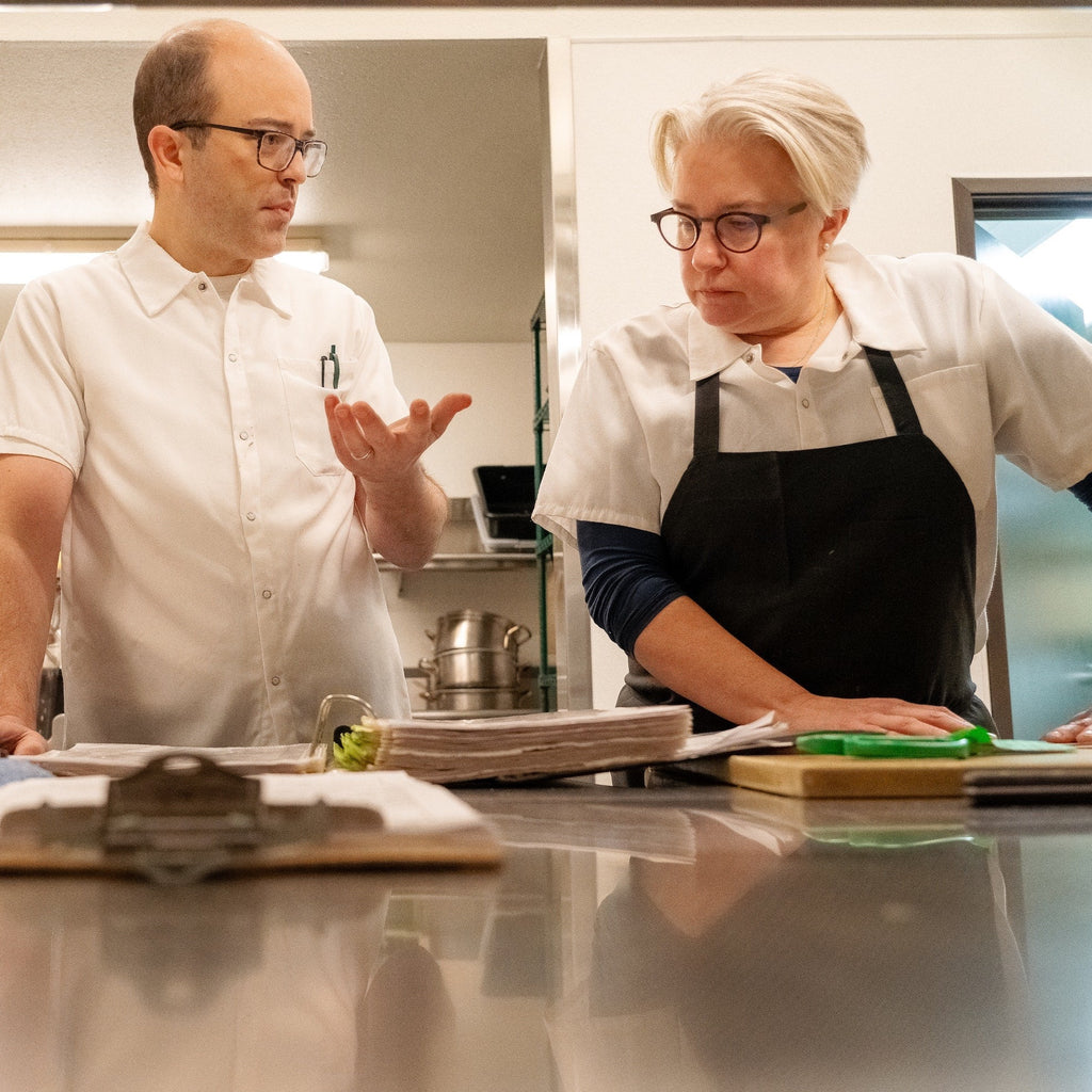 image of two chefs talking in a kitchen